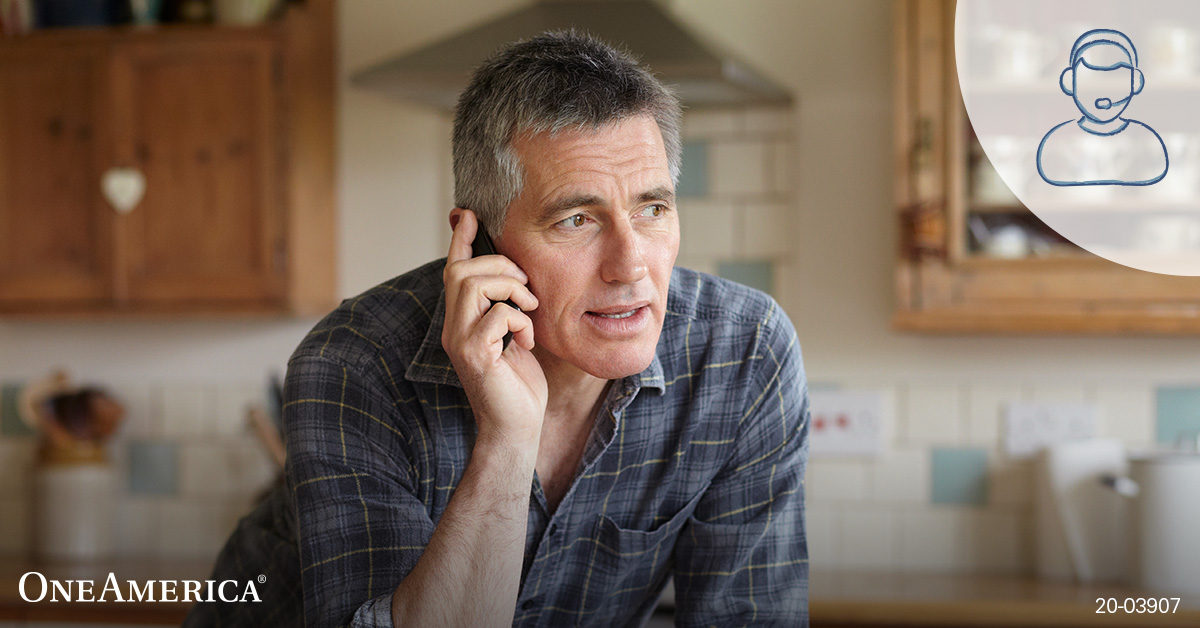 Man talking on cell phone in kitchen Man talking on cell phone in kitchen